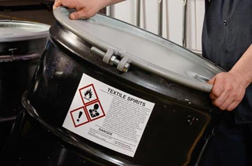 The label corrosive on a chemical container indicates