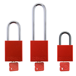 A set of three safety padlocks in various sizes and styles. Each padlock features a red aluminum body, a matching red key inserted in the cylinder, and a u-shaped metal shackle.