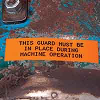 A rugged label on a piece of rusted metal equipment.