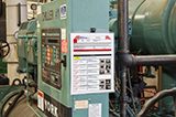 A lockout procedure posted on a chiller in an industrial environment.