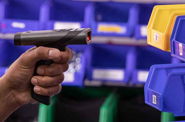 A hand-held RFID reader being used to verify product locations within a warehouse.