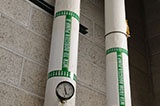 A set of green pipe markers indicate the direction of flow.