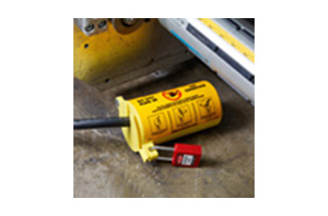 A lockout tagout device blocking access to a cord.