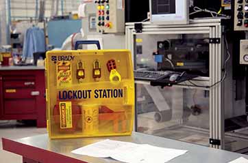 A box containing several padlocks and lockout devices.