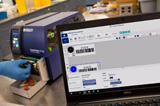 A Brady i7100 label printer applies custom designed barcode labels to lab tube samples.