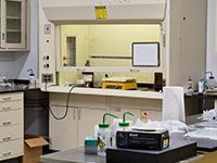Science laboratory interior from doorway entrance with various scientific equipment and tools.