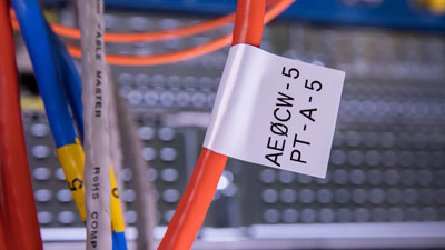 A wire has a flag label on it, showing two lines of text.